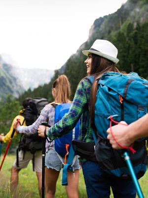 Adventure, travel, tourism, hike and people concept. Group of smiling friends with backpacks outdoors